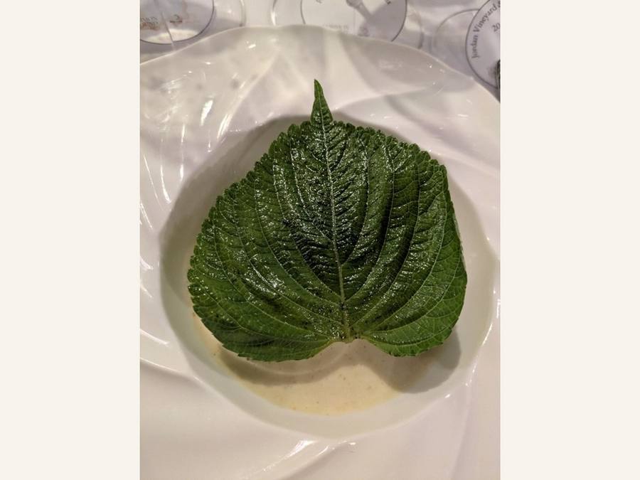 Bun Cha: a single large green leaf resting in a white bowl.