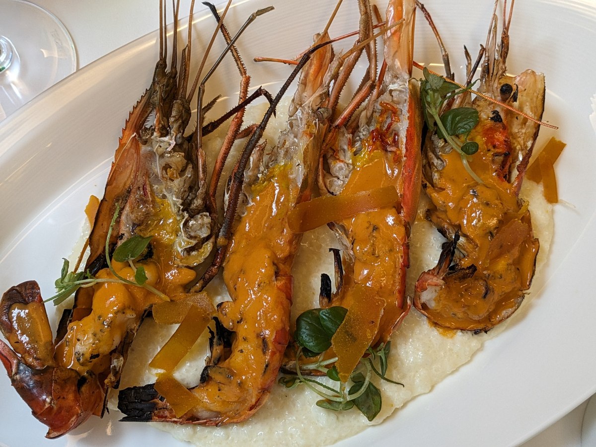 Grilled river prawns, split and glazed, on a bed of risotto.