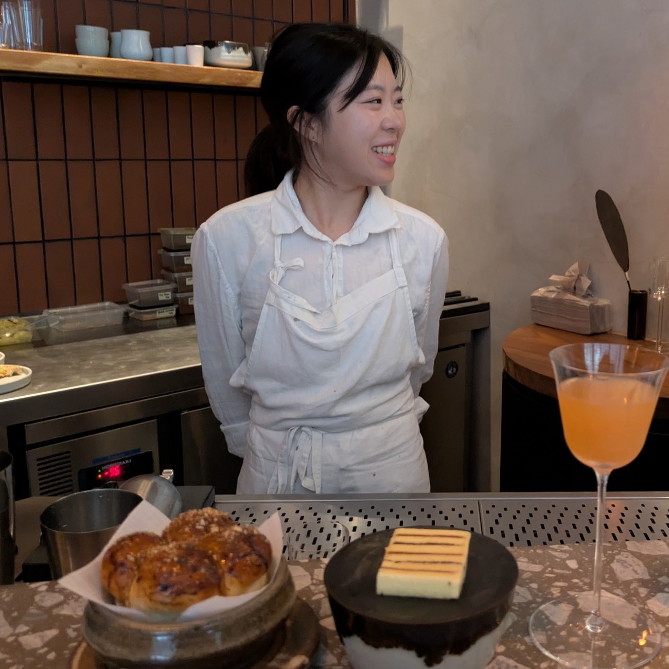 Chef Yujung Kim laughing behind the counter at ITO.