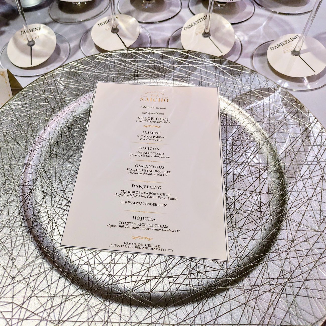 The Saicho Sparkling Tea menu card on a silver charger plate.